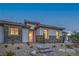 Welcoming front of house with stone accents, desert landscaping, and a brick walkway at 9 Rue Grimaldi Way, Henderson, NV 89011