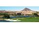 Scenic golf course with lake, desert mountain views, and elegant buildings providing a luxury golf experience at 9 Rue Grimaldi Way, Henderson, NV 89011