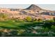 Scenic golf course with lush green fairways and sand traps, set against a backdrop of desert mountains at 9 Rue Grimaldi Way, Henderson, NV 89011