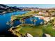 Beautiful golf course featuring a lake, palm trees, and luxury homes in the background, creating a serene atmosphere at 9 Rue Grimaldi Way, Henderson, NV 89011