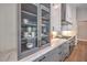 Bright kitchen featuring custom cabinets with glass door display, white countertops, and stainless-steel appliances at 9 Rue Grimaldi Way, Henderson, NV 89011