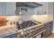 Modern kitchen showcasing stainless steel gas range with quartz countertops and light gray cabinetry at 9 Rue Grimaldi Way, Henderson, NV 89011