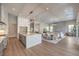 Open-concept kitchen with marble island, stainless appliances, hardwood floors and an adjacent living area at 9 Rue Grimaldi Way, Henderson, NV 89011