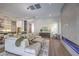 Open-concept living room with modern fireplace, seamless flow to kitchen and dining area at 9 Rue Grimaldi Way, Henderson, NV 89011