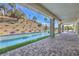 Inviting outdoor space with a long, narrow pool and tiled patio at 9 Rue Grimaldi Way, Henderson, NV 89011