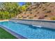 Backyard pool featuring a waterfall feature, lush greenery, and privacy at 9 Rue Grimaldi Way, Henderson, NV 89011