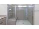 Modern bathroom with a glass shower featuring gray quartz walls and bench seating at 9086 Nostrand Ave, Las Vegas, NV 89148