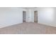 Spacious, carpeted bedroom featuring neutral walls and an open doorway to a bathroom at 9086 Nostrand Ave, Las Vegas, NV 89148