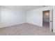 Carpeted bedroom with white walls featuring an open doorway to the bathroom at 9086 Nostrand Ave, Las Vegas, NV 89148