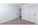 Bedroom with closet and view into another room. Neutral walls and carpet at 9086 Nostrand Ave, Las Vegas, NV 89148
