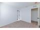 Bedroom with neutral walls, carpet and a view into two separate rooms at 9086 Nostrand Ave, Las Vegas, NV 89148