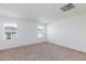 Bright, carpeted bedroom with white walls, two windows, and recessed lighting at 9086 Nostrand Ave, Las Vegas, NV 89148