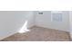 Bright bedroom with neutral carpet, white walls, and natural light from the windows at 9086 Nostrand Ave, Las Vegas, NV 89148
