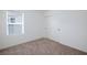 Bedroom featuring neutral walls, carpet, a large window, and a closet at 9086 Nostrand Ave, Las Vegas, NV 89148