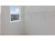 Closet with shelving unit, neutral walls, carpet and natural light from the window at 9086 Nostrand Ave, Las Vegas, NV 89148
