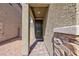 Covered front porch featuring stone accents, pavers and a dark-colored door at 9086 Nostrand Ave, Las Vegas, NV 89148