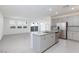 Open-concept kitchen and living space, stainless appliances and tiled floors at 9086 Nostrand Ave, Las Vegas, NV 89148