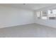 Bright living room with large windows providing plenty of natural light and tile floors at 9086 Nostrand Ave, Las Vegas, NV 89148
