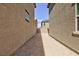 Narrow side yard with gravel and partial block wall at 9086 Nostrand Ave, Las Vegas, NV 89148