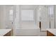 Bright bathroom featuring a soaking tub, glass enclosed shower, and tiled floors at 9190 Wine Cellar Ave, Las Vegas, NV 89148