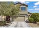 Charming two-story home with a neutral exterior, attached garage, and mature trees in the front yard at 9190 Wine Cellar Ave, Las Vegas, NV 89148