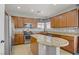 Well-lit kitchen featuring tan cabinets, granite countertops, stainless steel appliances and tile flooring at 9190 Wine Cellar Ave, Las Vegas, NV 89148
