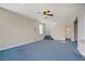 Spacious living room with blue carpet and stairs leading to the second story at 9190 Wine Cellar Ave, Las Vegas, NV 89148