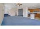 Open concept living room flowing into the kitchen, stairs, and entryway at 9190 Wine Cellar Ave, Las Vegas, NV 89148