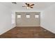 Spacious living area with ceiling fan, light-colored walls, and durable dark hardwood flooring at 9190 Wine Cellar Ave, Las Vegas, NV 89148