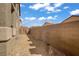 Low maintenance side yard with gravel and secure fencing for added privacy at 9190 Wine Cellar Ave, Las Vegas, NV 89148
