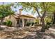 The backyard features desert landscaping, mature trees, and a screened-in patio for relaxing and enjoying the outdoors at 9329 January Dr, Las Vegas, NV 89134