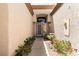 Charming entryway with a beautiful front door, desert landscaping, and a textured exterior wall at 9329 January Dr, Las Vegas, NV 89134