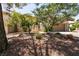 Beautifully landscaped front yard with lush greenery, a mature tree, and a two-car garage at 9329 January Dr, Las Vegas, NV 89134
