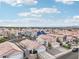 Expansive aerial view of a residential community featuring single-Gathering homes under a bright, partly cloudy sky at 9333 Jumpin Juniper Ave, Las Vegas, NV 89129