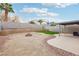 Backyard features an artificial lawn, fire pit area, and covered patio at 9333 Jumpin Juniper Ave, Las Vegas, NV 89129