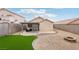 A private backyard with a covered patio is complemented by desert landscaping and a fire pit at 9333 Jumpin Juniper Ave, Las Vegas, NV 89129