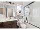 Stylish bathroom with a dark wood vanity, white countertops, and a sleek glass-enclosed shower at 9333 Jumpin Juniper Ave, Las Vegas, NV 89129