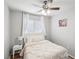Charming bedroom with a ceiling fan, window with white curtains, and a cozy queen-size bed at 9333 Jumpin Juniper Ave, Las Vegas, NV 89129