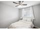 Bright bedroom features a cozy queen-size bed, ceiling fan and a bright window with white curtains at 9333 Jumpin Juniper Ave, Las Vegas, NV 89129