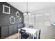 Modern dining area featuring a white table, blue chairs, and decorative wall accents at 9333 Jumpin Juniper Ave, Las Vegas, NV 89129