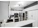 Well-lit kitchen features stainless steel appliances, ample white cabinetry, counter space and modern lighting at 9333 Jumpin Juniper Ave, Las Vegas, NV 89129