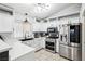 Bright kitchen with white cabinets, stainless steel appliances, and modern lighting fixtures at 9333 Jumpin Juniper Ave, Las Vegas, NV 89129
