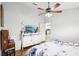Comfortable main bedroom featuring ceiling fan, dresser, and a kitchen view at 9333 Jumpin Juniper Ave, Las Vegas, NV 89129