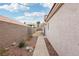 Side yard features a gravel landscape, sidewalk, and block fence at 9333 Jumpin Juniper Ave, Las Vegas, NV 89129