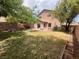 Large backyard offers an open patio, grass area, mature trees, and a fully fenced perimeter at 11117 Okeefe Ct, Las Vegas, NV 89144