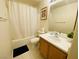 Well-lit bathroom featuring a shower/tub combo and vanity with ceramic tile floors at 11117 Okeefe Ct, Las Vegas, NV 89144