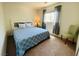 Cozy bedroom featuring a light blue bedspread, a window for natural light, and neutral wall color at 11117 Okeefe Ct, Las Vegas, NV 89144