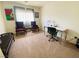 Inviting bedroom with plush carpet, a cozy seating area, and an office desk at 11117 Okeefe Ct, Las Vegas, NV 89144