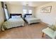 Bright bedroom featuring two beds with patterned bedding, two windows and carpet at 11117 Okeefe Ct, Las Vegas, NV 89144