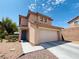 Charming two-story home has a well-maintained yard and convenient attached two-car garage at 11117 Okeefe Ct, Las Vegas, NV 89144
